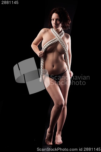 Image of Pretty topless woman body covering by rope