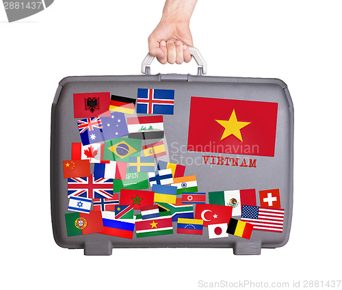 Image of Used plastic suitcase with stickers