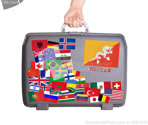 Image of Used plastic suitcase with stickers