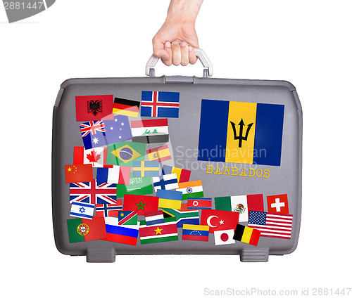 Image of Used plastic suitcase with stickers