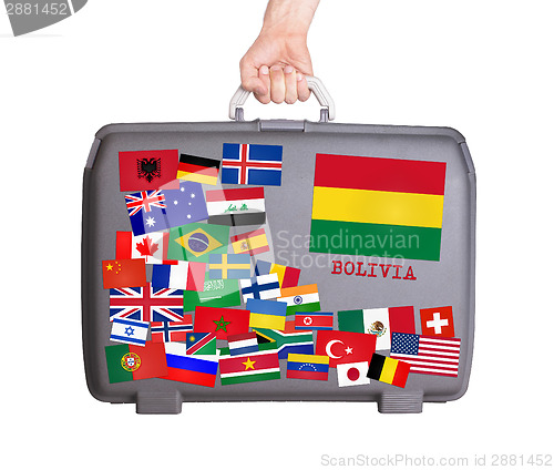 Image of Used plastic suitcase with stickers