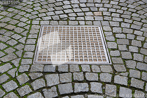 Image of Paving stones with metal manhole