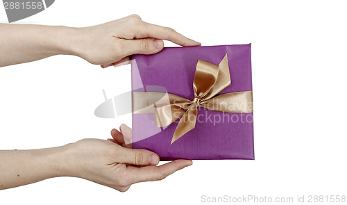 Image of Young woman holding a present