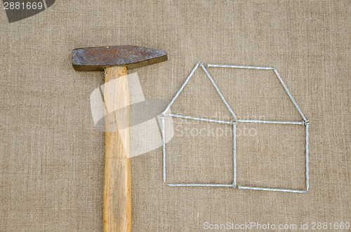 Image of hammer and outbuilding form of nail linen texture  