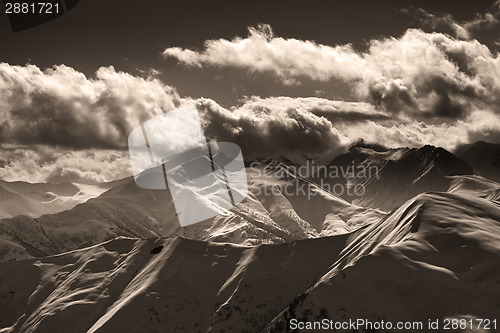 Image of Sepia evening mountains and sunlight clouds
