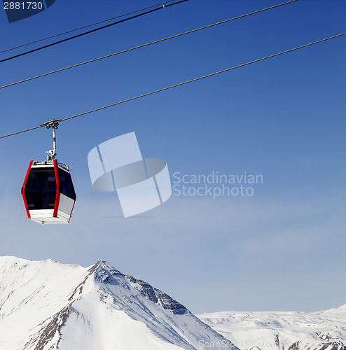 Image of Gondola lift and snowy mountains