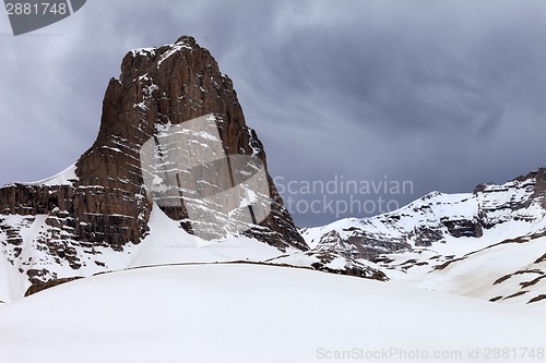 Image of Snowy rocks and grey sky