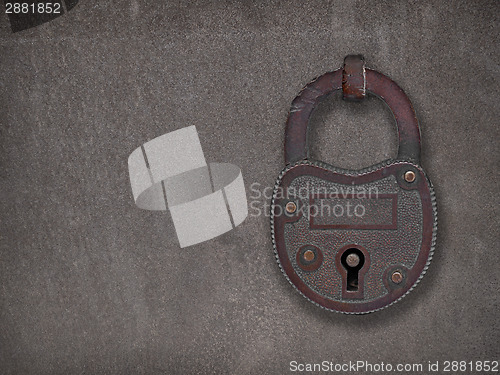 Image of padlock on a rusty steel plate