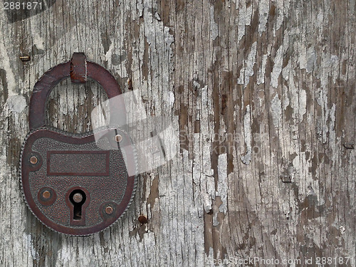 Image of vintage padlock on a old door