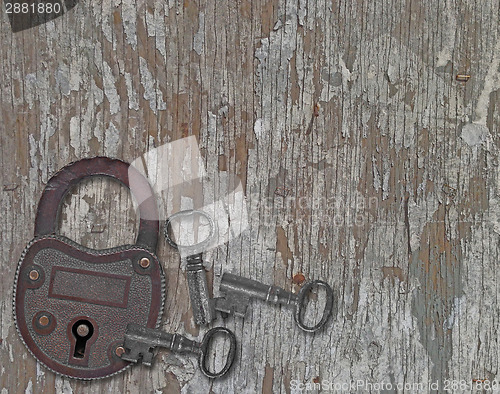 Image of vintage padlock on a old wooden panel