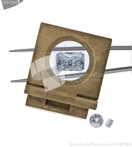 Image of  vintage loupe over diamond and tweezers