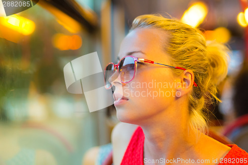 Image of Woman looking out tram's window.