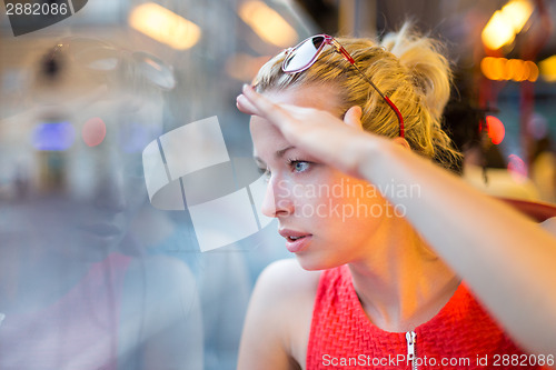 Image of Woman looking out tram's window.