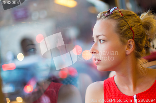 Image of Woman looking out tram's window.