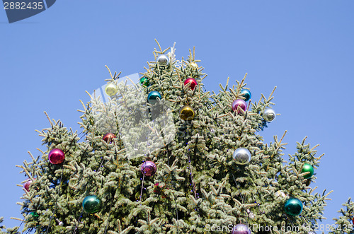 Image of christmas tree glassy ball on blue sky background 