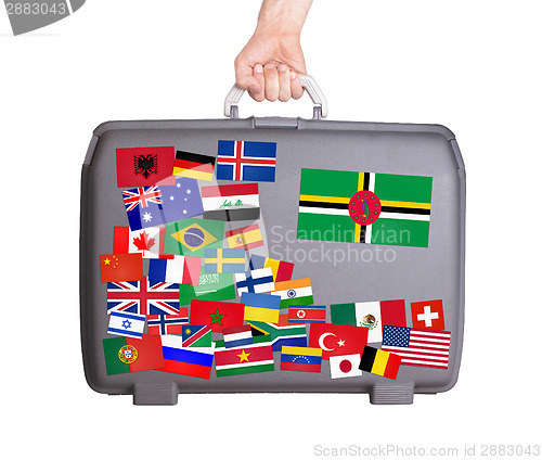 Image of Used plastic suitcase with stickers