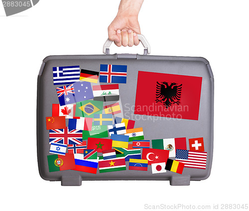 Image of Used plastic suitcase with stickers