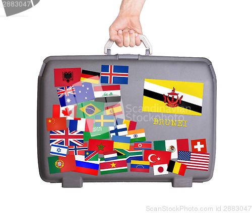 Image of Used plastic suitcase with stickers