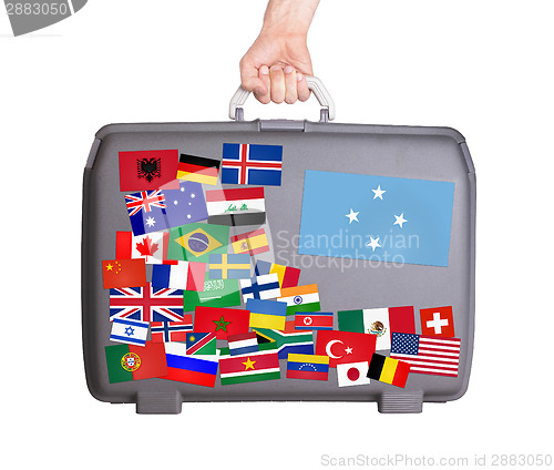 Image of Used plastic suitcase with stickers