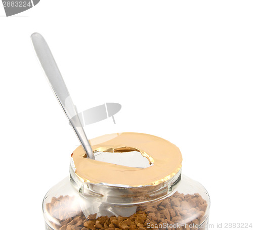 Image of Teaspoon in a freshly opened jar of aromatic coffee 