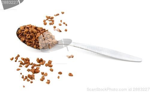 Image of Teaspoon of instant coffee, some granules spilled 