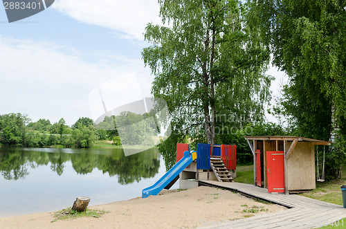 Image of changing cabin and water slide at beach shore 