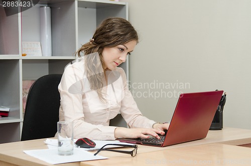 Image of Young girl at a laptop in the office