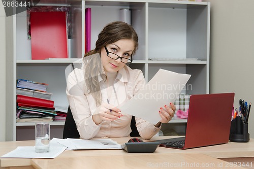 Image of Business office girl reading a document