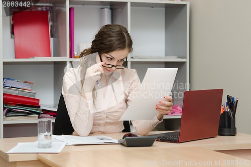 Image of Girl reading a document in the workplace