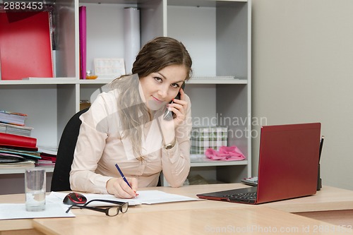 Image of Business woman calling by phone in the workplace