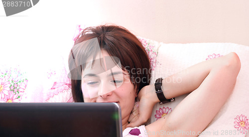 Image of Young woman with laptop 