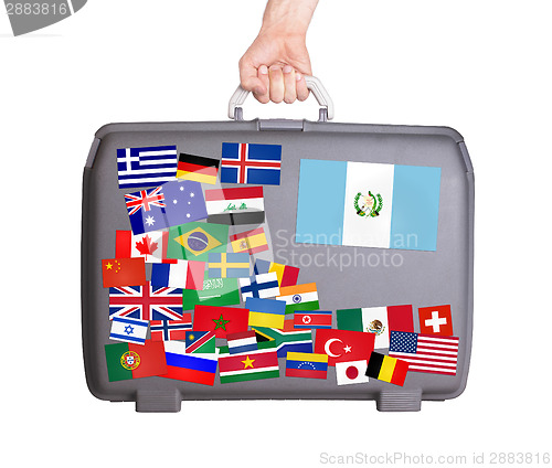 Image of Used plastic suitcase with stickers