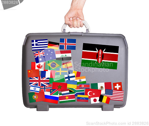 Image of Used plastic suitcase with stickers