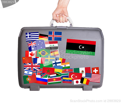 Image of Used plastic suitcase with stickers