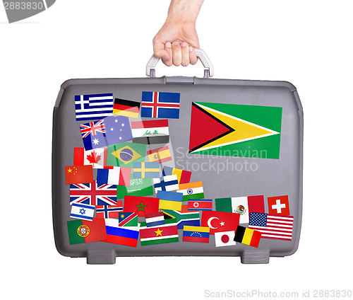 Image of Used plastic suitcase with stickers