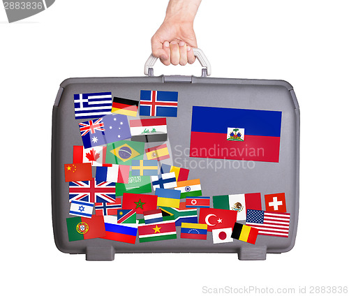 Image of Used plastic suitcase with stickers