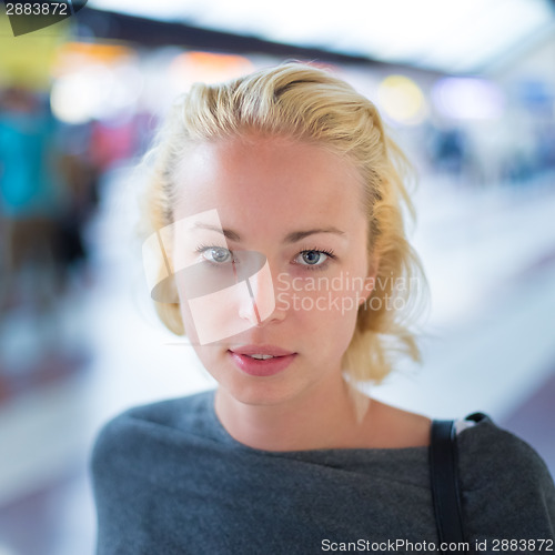 Image of Young woman on platform of railway station.