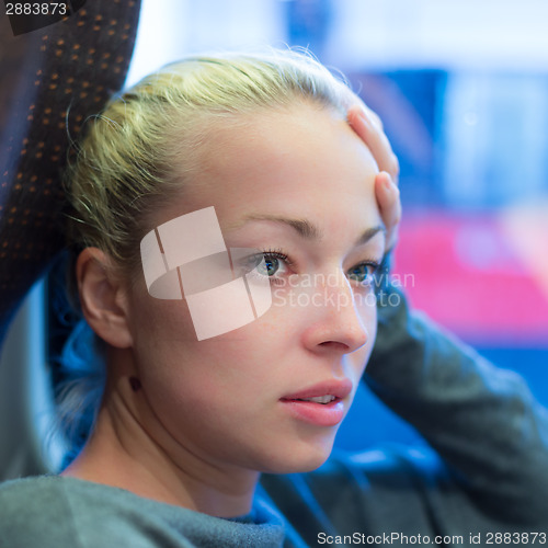 Image of Woman looking out tram's window.