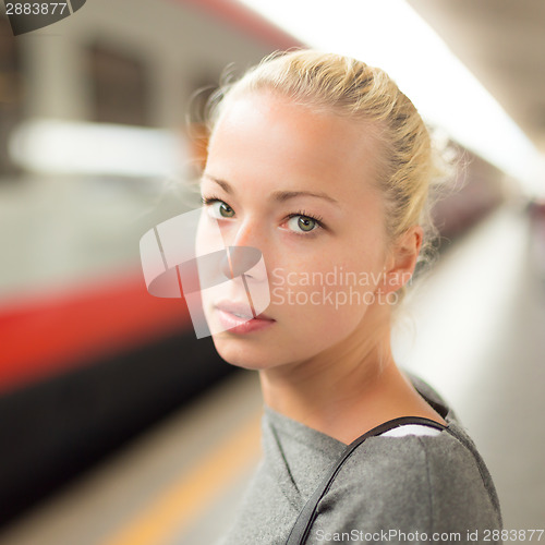 Image of Young woman on platform of railway station.