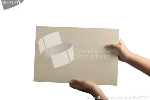 Image of Plywood sign held up by young hands