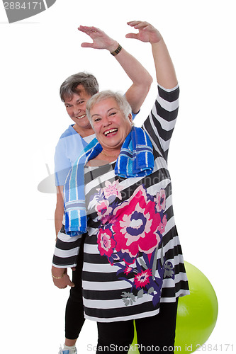 Image of Two senior women doing gym exercises