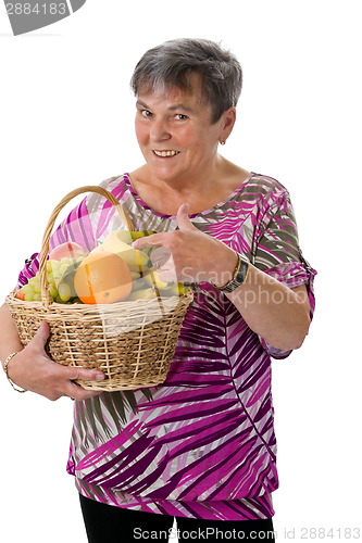 Image of Senior woman presenting fruit