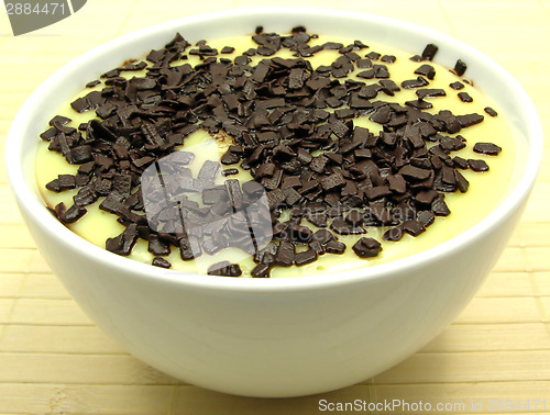 Image of Custard with grated chocolate in a bowl of china ware