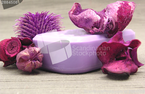 Image of Lilac soap with decoration articles on a  gray  background