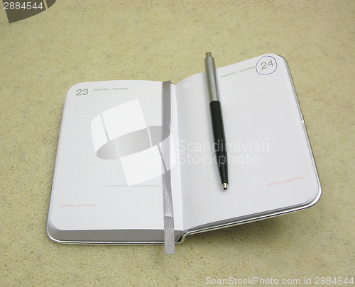 Image of To flip an appointment calendar open with ball pen