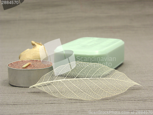 Image of Green soap with decoration articles on a  gray  background