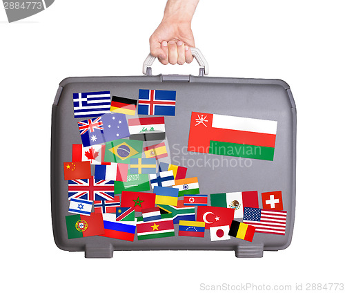 Image of Used plastic suitcase with stickers