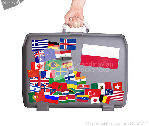 Image of Used plastic suitcase with stickers