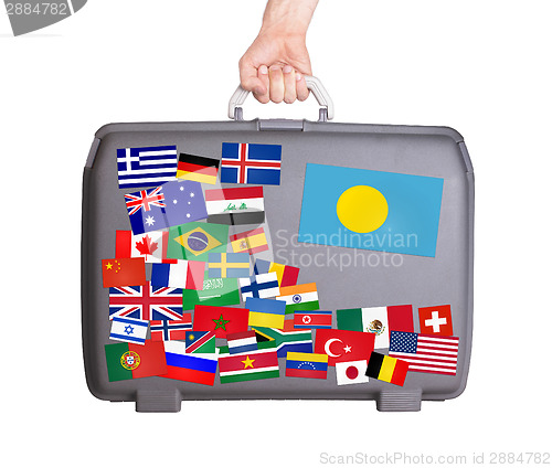 Image of Used plastic suitcase with stickers