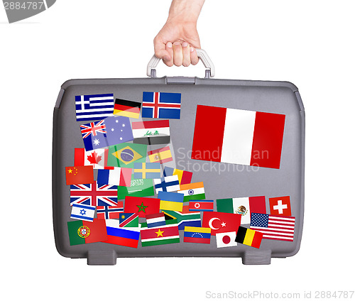 Image of Used plastic suitcase with stickers